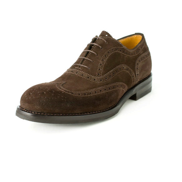 A brown suede men's dress shoe with a lace-up closure and brogue detailing.